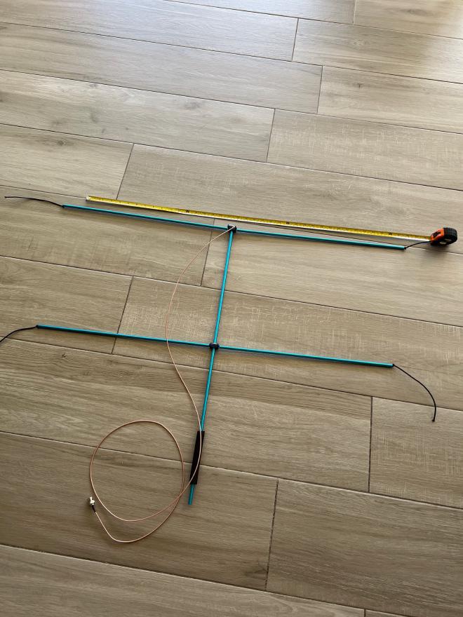 assembled antenna on floor with measuring tape for scale