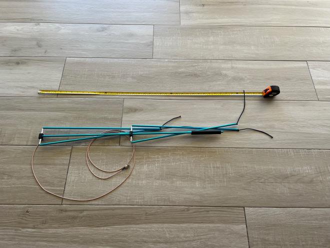 Antenna shown collapsed on the floor with tape measure for scale
